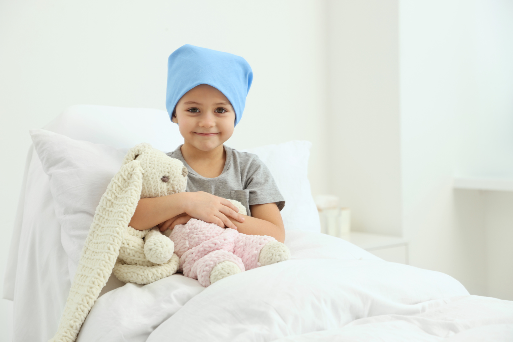 Childhood Cancer. Girl with Toy Bunny in Hospital